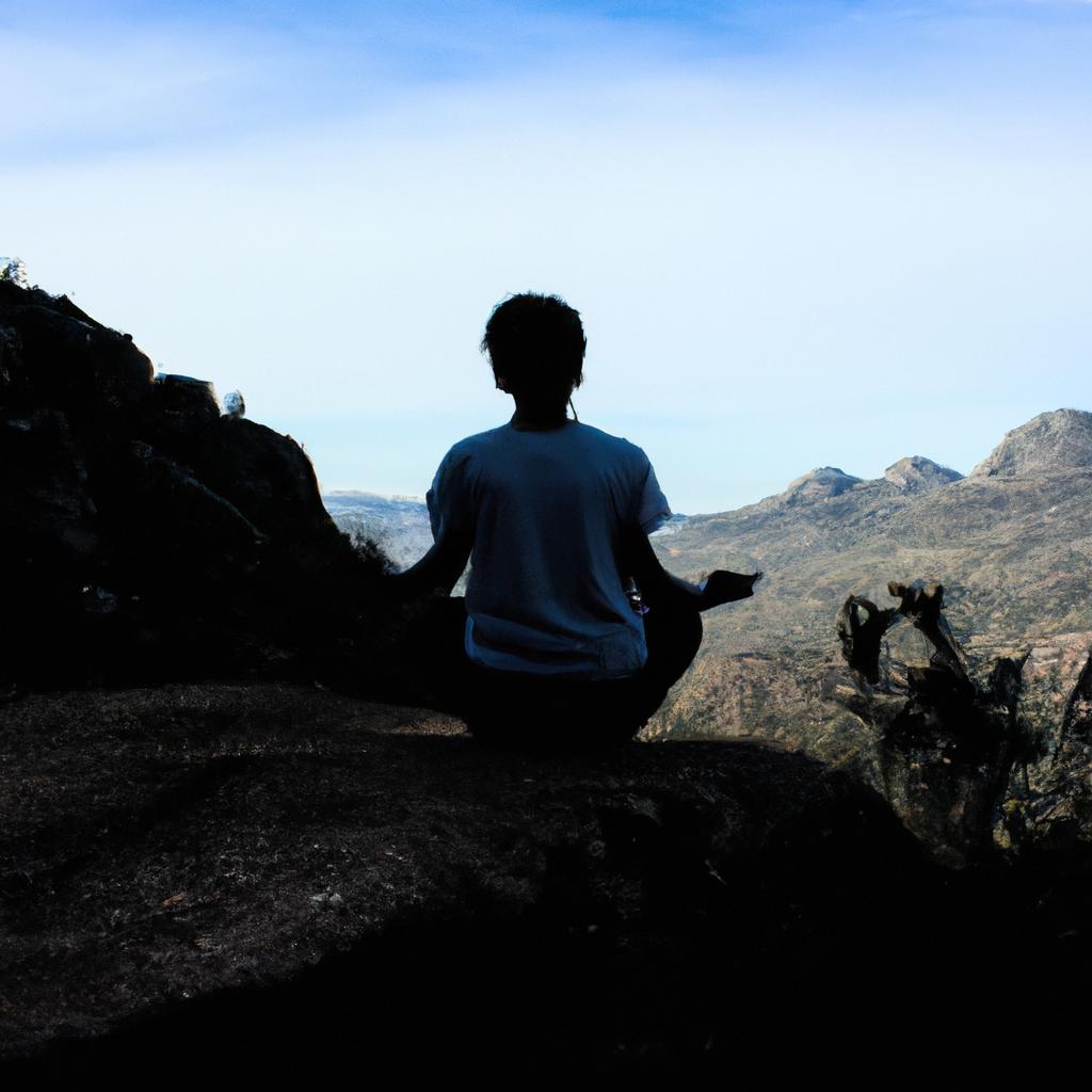 Person meditating on a mountain